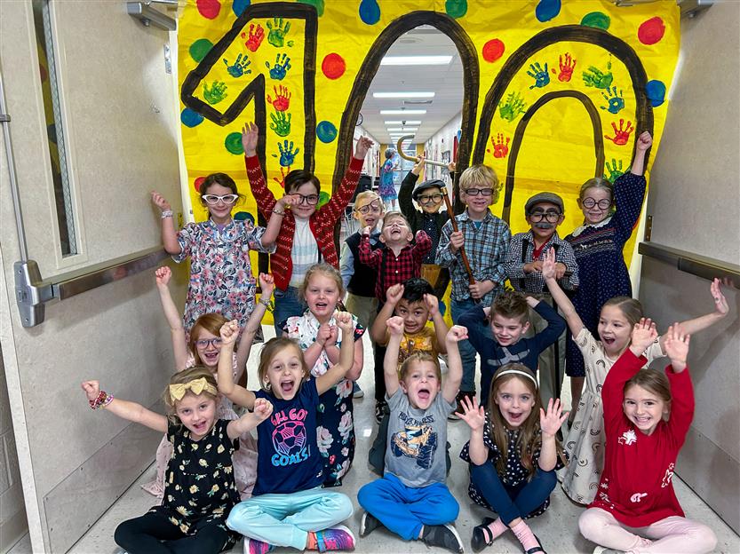 group of students under a 100 sign
